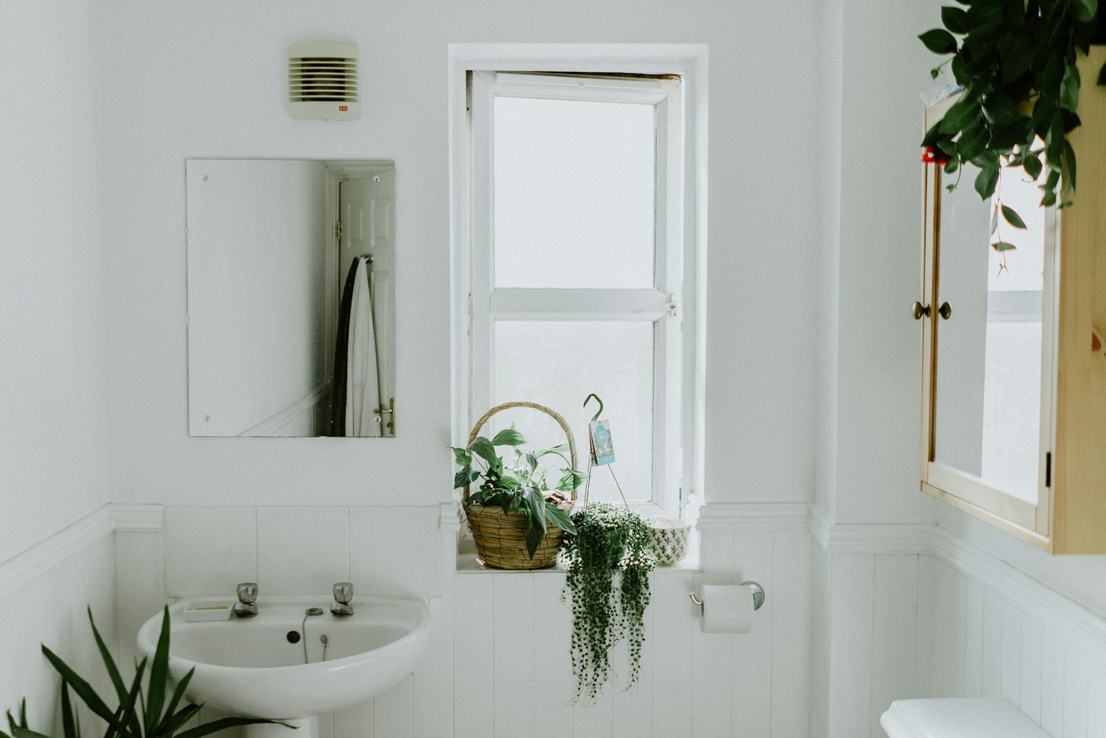 A neatly styled set of storage baskets and everyday objects arranged on a warm surface